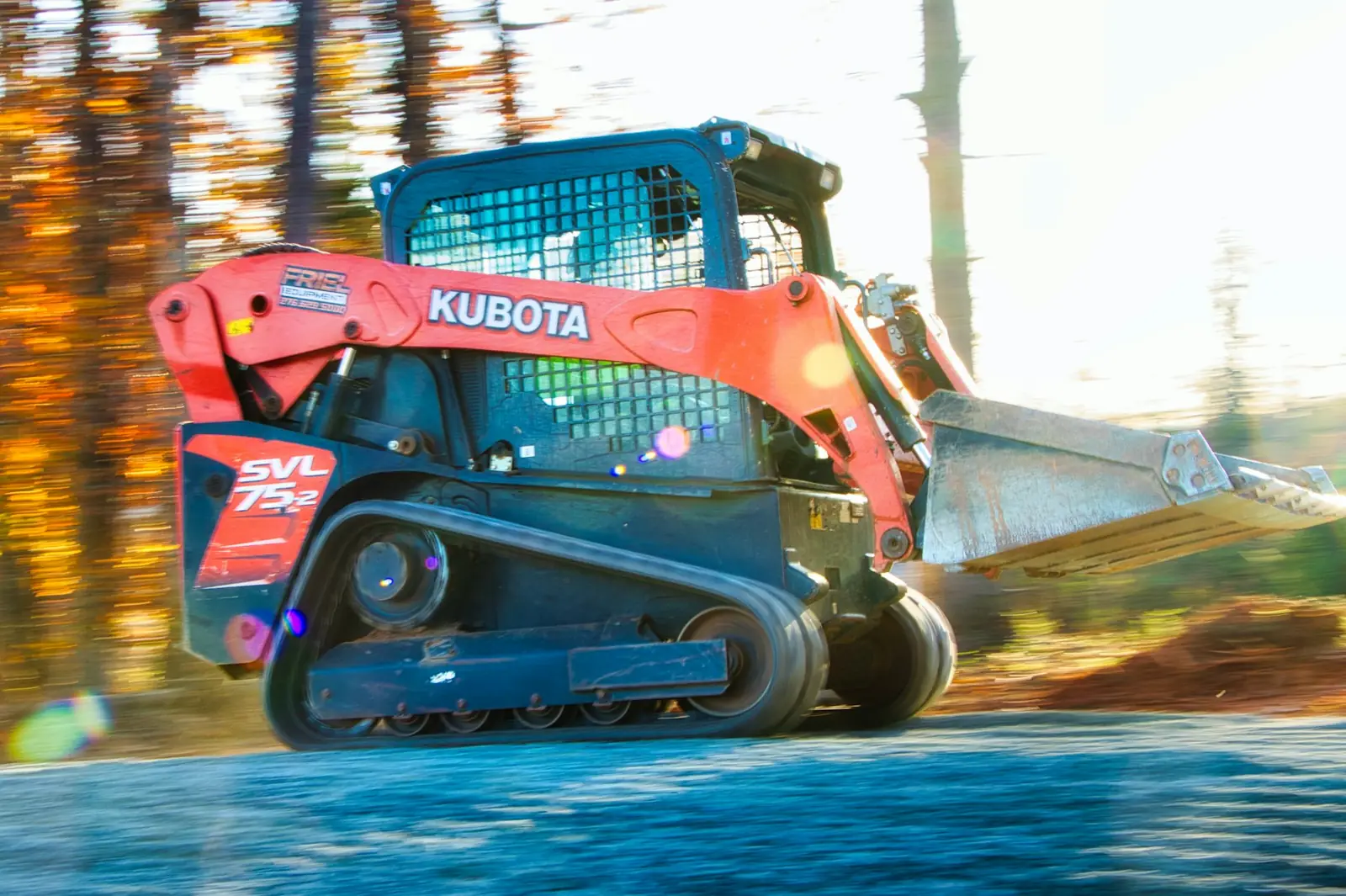 Compact track loader moving at speed
